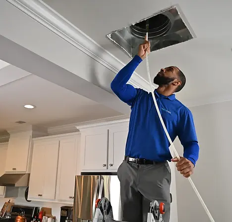 Supreme Air Duct Cleaners technician performing professional air duct cleaning in an Orlando home