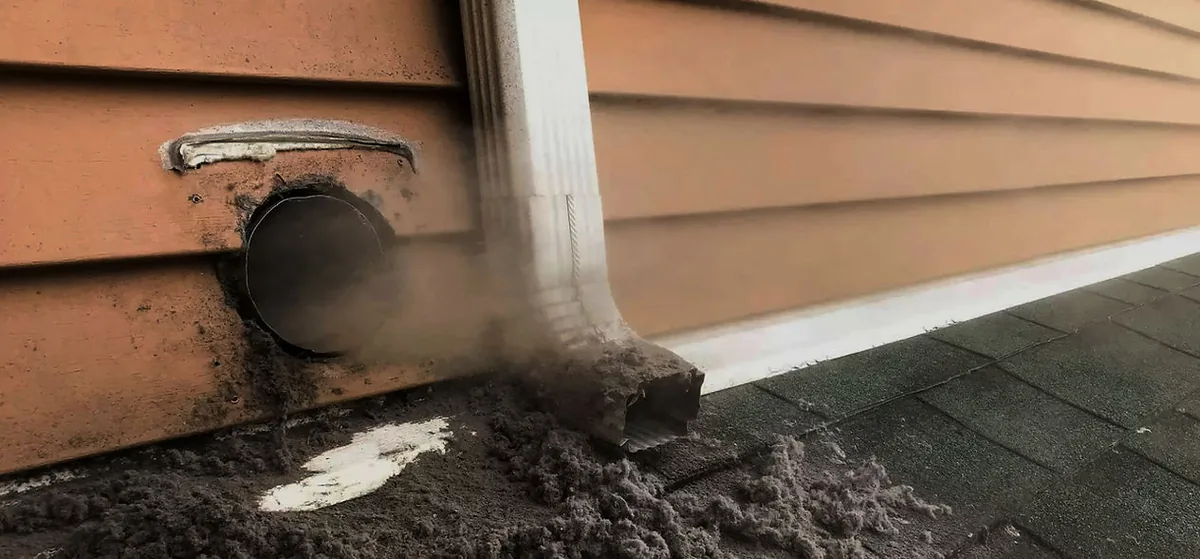 Supreme Air Duct Cleaners technician cleaning a dryer vent to prevent fire hazards in an Orlando home